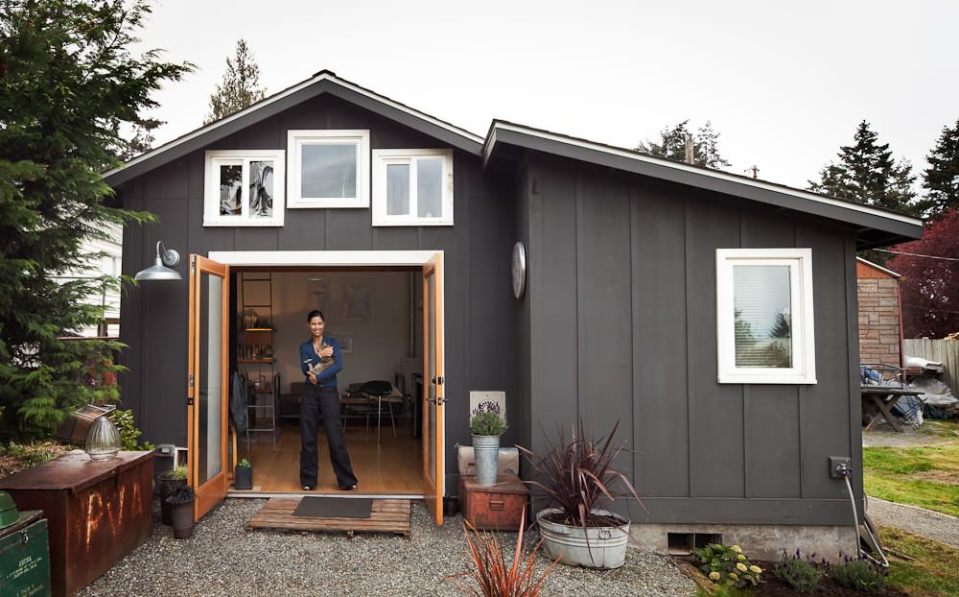 A single-car garage converted into a tiny house with a sleeping loft. | www.facebook.com/SmallHouseBliss