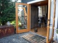 A single-car garage converted into a tiny house with a sleeping loft. | www.facebook.com/SmallHouseBliss
