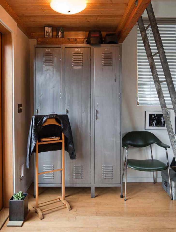 A single-car garage converted into a tiny house with a sleeping loft. | www.facebook.com/SmallHouseBliss