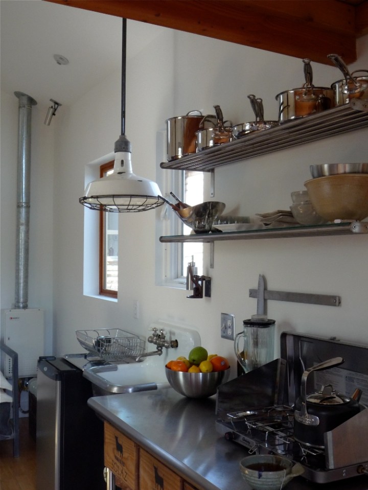 A single-car garage converted into a tiny house with a sleeping loft. | www.facebook.com/SmallHouseBliss