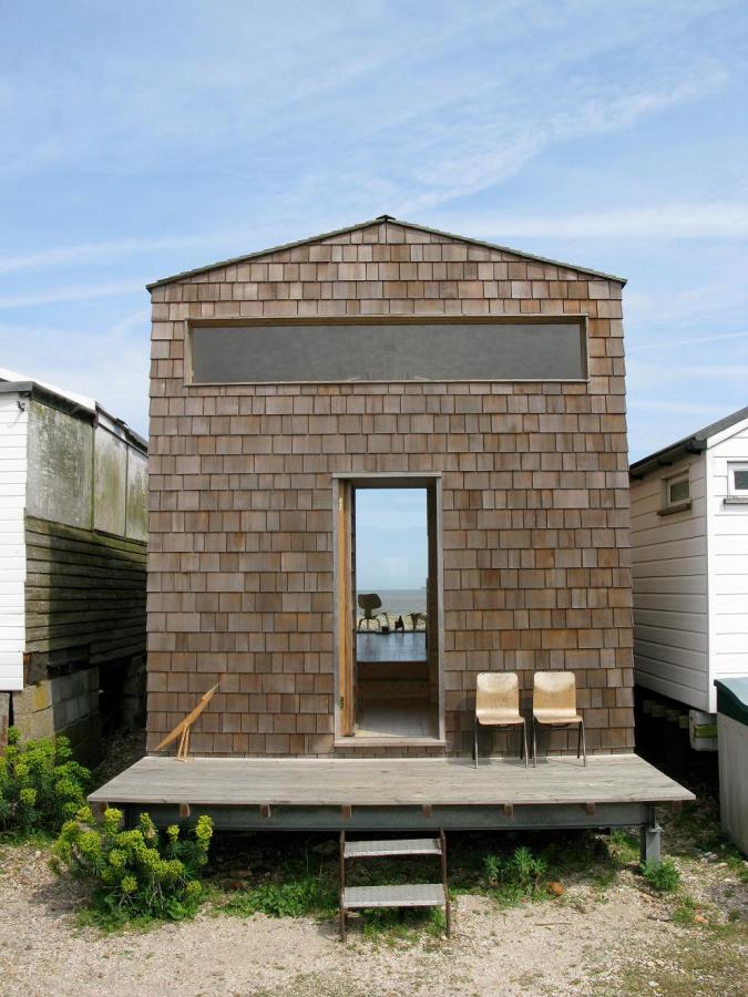 Designer Nina Tolstrup's tiny beach hut comfortably accommodates her family of four in its 388 sq ft. | www.facebook.com/SmallHouseBliss