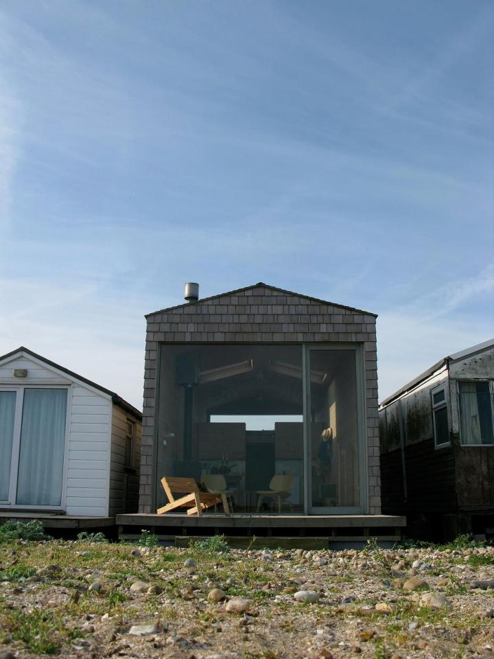 Designer Nina Tolstrup's tiny beach hut comfortably accommodates her family of four in its 388 sq ft. | www.facebook.com/SmallHouseBliss