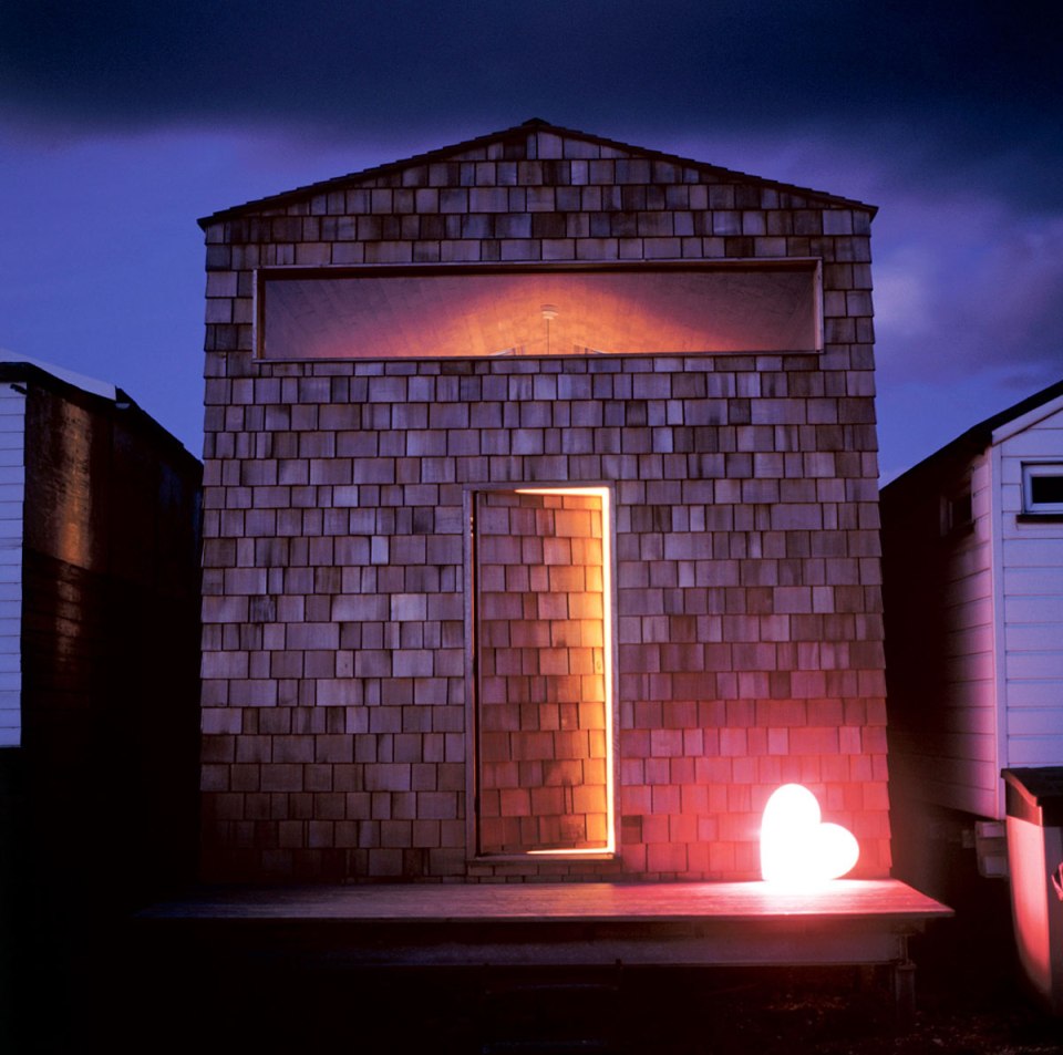 Designer Nina Tolstrup's tiny beach hut comfortably accommodates her family of four in its 388 sq ft. | www.facebook.com/SmallHouseBliss