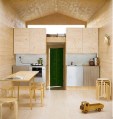 Designer Nina Tolstrup's tiny beach hut comfortably accommodates her family of four in its 388 sq ft. | www.facebook.com/SmallHouseBliss