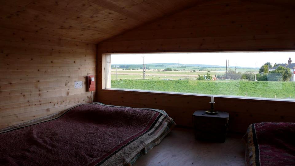 Designer Nina Tolstrup's tiny beach hut comfortably accommodates her family of four in its 388 sq ft. | www.facebook.com/SmallHouseBliss
