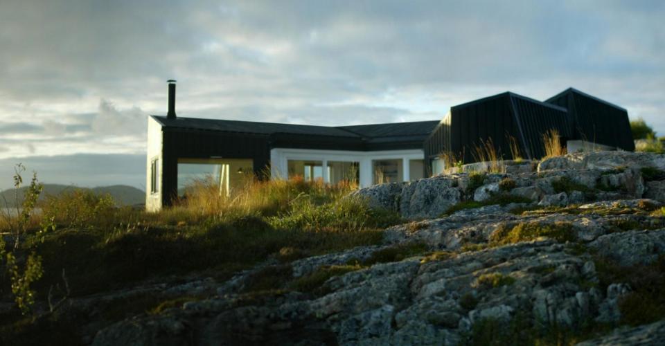 An irregular horseshoe-shaped floor plan provides shelter from the wind for this family cabin in Norway. It has 3 bedrooms in 829 sq ft. | www.facebook.com/SmallHouseBliss