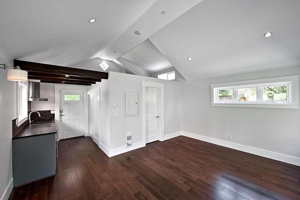 A small laneway house designed to blend with its traditional neighbors. The 400 sq ft cottage is a studio design with a sleeping loft. | www.facebook.com/SmallHouseBliss