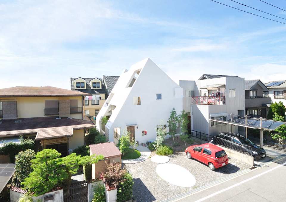 This small house for a family features terraces cut into the steeply pitched roof. | www.facebook.com/SmallHouseBliss
