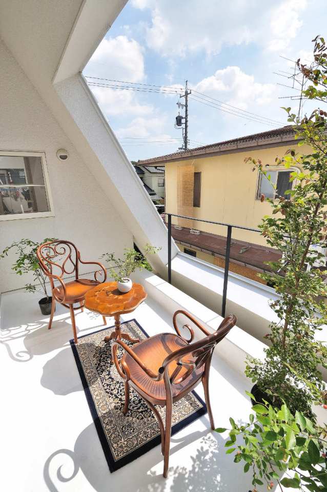 This small house for a family features terraces cut into the steeply pitched roof. | www.facebook.com/SmallHouseBliss