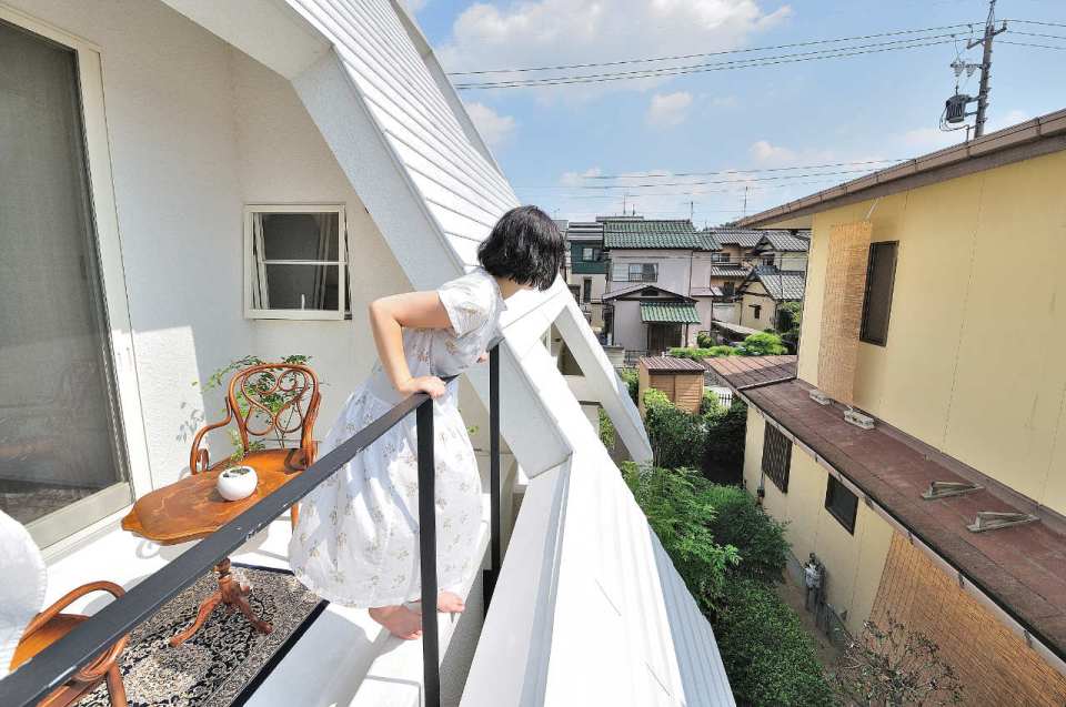 This small house for a family features terraces cut into the steeply pitched roof. | www.facebook.com/SmallHouseBliss