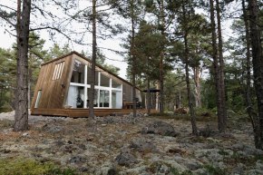 This modern resort cabin in Sweden has a design inspired by camping tents. It has two bedrooms and a loft in 969 sq ft. | www.facebook.com/SmallHouseBliss