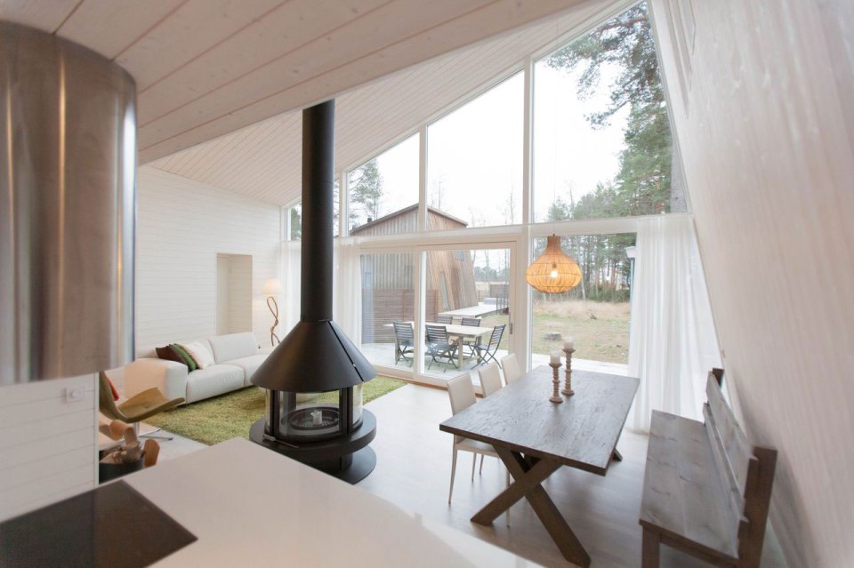 This modern resort cabin in Sweden has a design inspired by camping tents. It has two bedrooms and a loft in 969 sq ft. | www.facebook.com/SmallHouseBliss