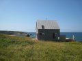 Sea and Sky Cottage on Cape Breton updates the traditional Maritime gable-roofed, shingled house with an open interior. It is 860 sq ft with a lofted bedroom. | www.facebook.com/SmallHouseBliss