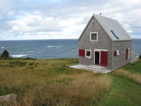 Sea and Sky Cottage on Cape Breton updates the traditional Maritime gable-roofed, shingled house with an open interior. It is 860 sq ft with a lofted bedroom. | www.facebook.com/SmallHouseBliss
