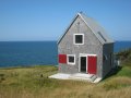 Sea and Sky Cottage on Cape Breton updates the traditional Maritime gable-roofed, shingled house with an open interior. It is 860 sq ft with a lofted bedroom. | www.facebook.com/SmallHouseBliss