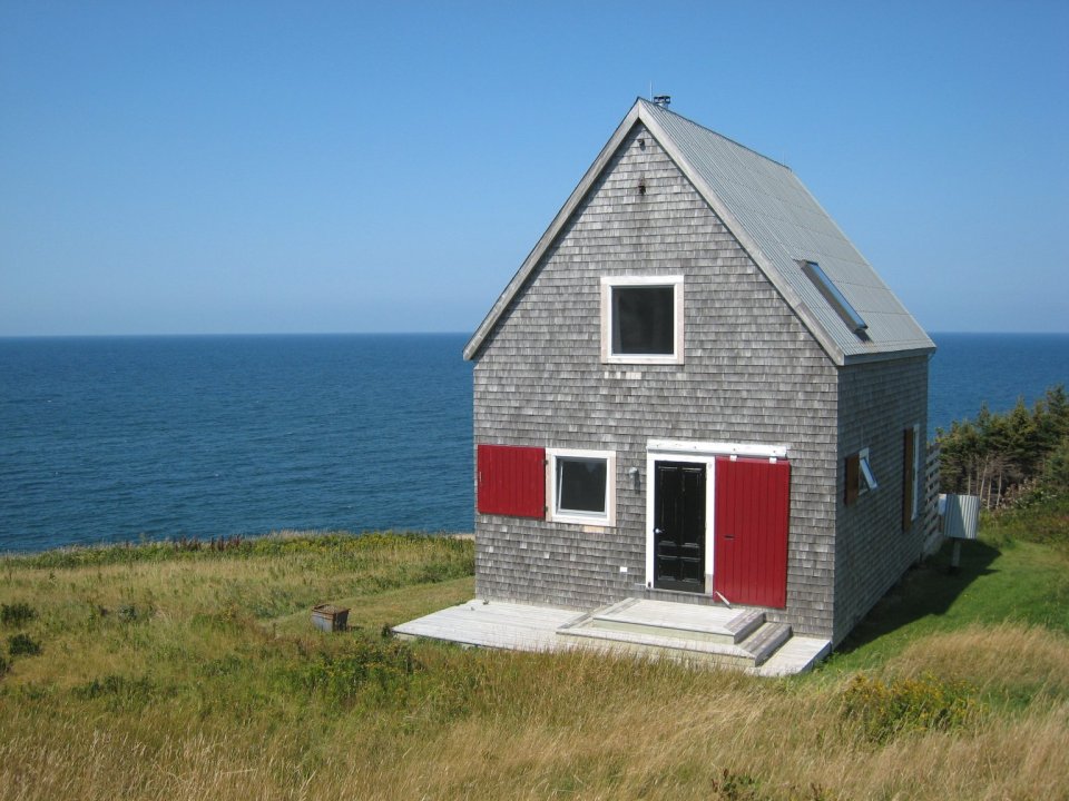Sea and Sky Cottage on Cape Breton updates the traditional Maritime gable-roofed, shingled house with an open interior. It is 860 sq ft with a lofted bedroom. | www.facebook.com/SmallHouseBliss