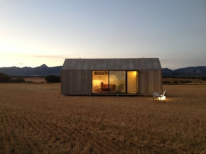 The ÁPH80 Transportable House, a tiny prefab with a minimalist design aesthetic, has one bedroom in 291 sq ft. | www.facebook.com/SmallHouseBliss