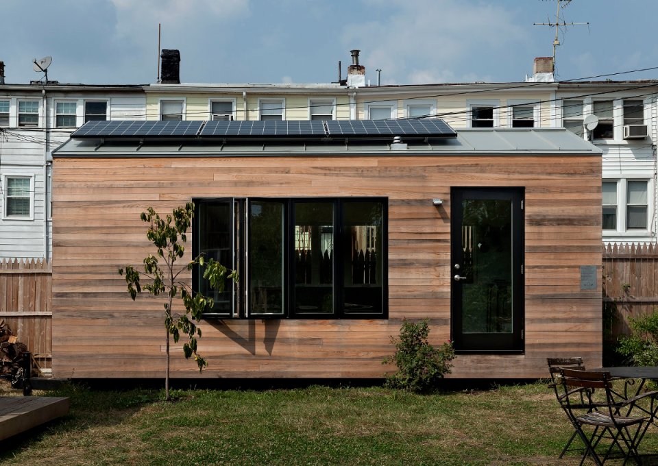 Minim House, a 242 sq ft tiny house with multi-functional furniture and a pull-out bed instead of the usual sleeping loft. | www.facebook.com/SmallHouseBliss