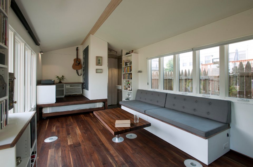 Minim House, a 242 sq ft tiny house with multi-functional furniture and a pull-out bed instead of the usual sleeping loft. | www.facebook.com/SmallHouseBliss