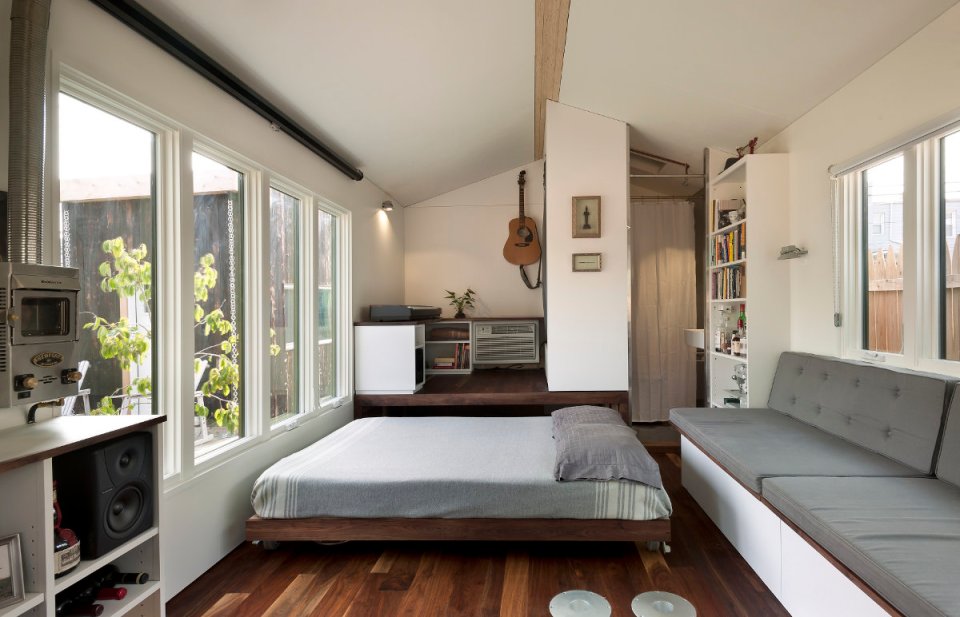 Minim House, a 242 sq ft tiny house with multi-functional furniture and a pull-out bed instead of the usual sleeping loft. | www.facebook.com/SmallHouseBliss