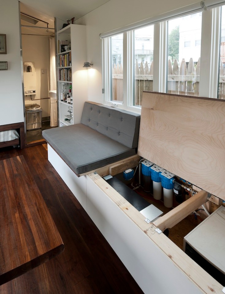 Minim House, a 242 sq ft tiny house with multi-functional furniture and a pull-out bed instead of the usual sleeping loft. | www.facebook.com/SmallHouseBliss