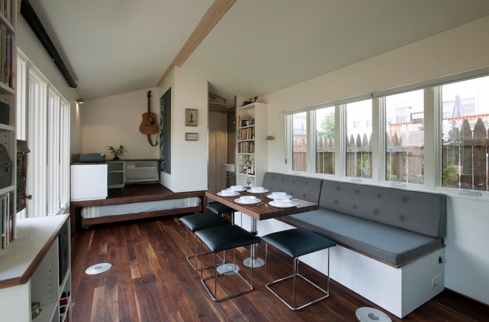 Minim House, a 242 sq ft tiny house with multi-functional furniture and a pull-out bed instead of the usual sleeping loft. | www.facebook.com/SmallHouseBliss