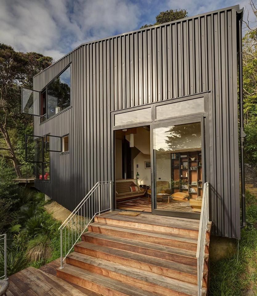 This vertically-oriented house with 1 bedroom and a small loft in 872 sq ft uses a split-level design to step down its steep site. | www.facebook.com/SmallHouseBliss