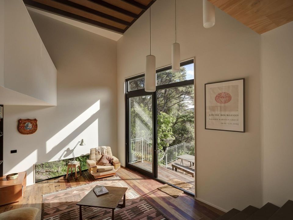 This vertically-oriented house with 1 bedroom and a small loft in 872 sq ft uses a split-level design to step down its steep site. | www.facebook.com/SmallHouseBliss