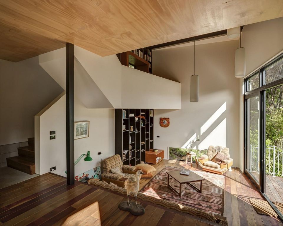 This vertically-oriented house with 1 bedroom and a small loft in 872 sq ft uses a split-level design to step down its steep site. | www.facebook.com/SmallHouseBliss