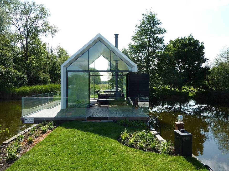 This tiny 226 sq ft lake house opens to the outdoors with a folding wall. 2by4-architects has also designed a prefab version. | www.facebook.com/SmallHouseBliss