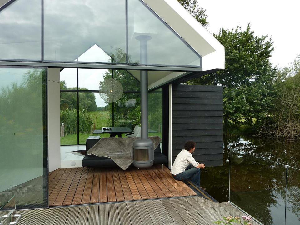 This tiny 226 sq ft lake house opens to the outdoors with a folding wall. 2by4-architects has also designed a prefab version. | www.facebook.com/SmallHouseBliss