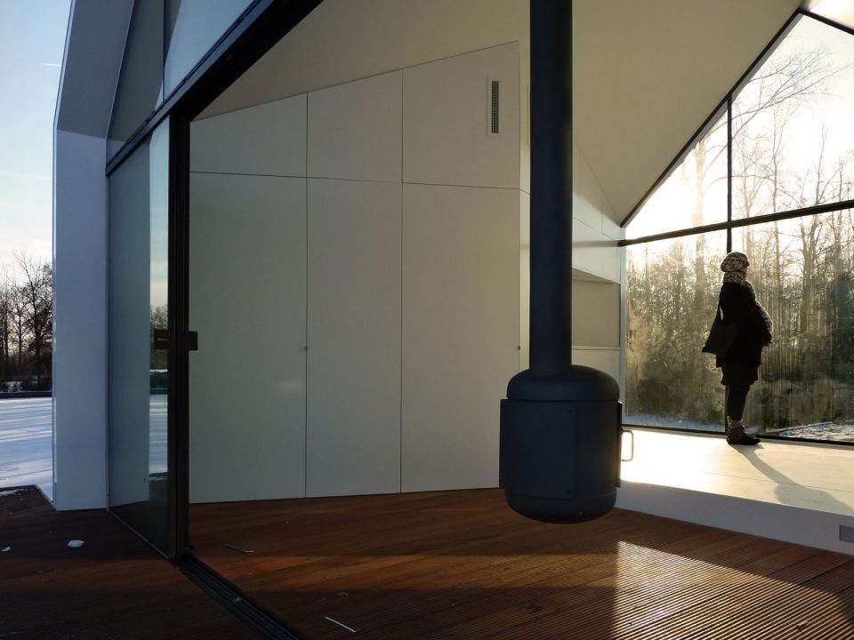 This tiny 226 sq ft lake house opens to the outdoors with a folding wall. 2by4-architects has also designed a prefab version. | www.facebook.com/SmallHouseBliss