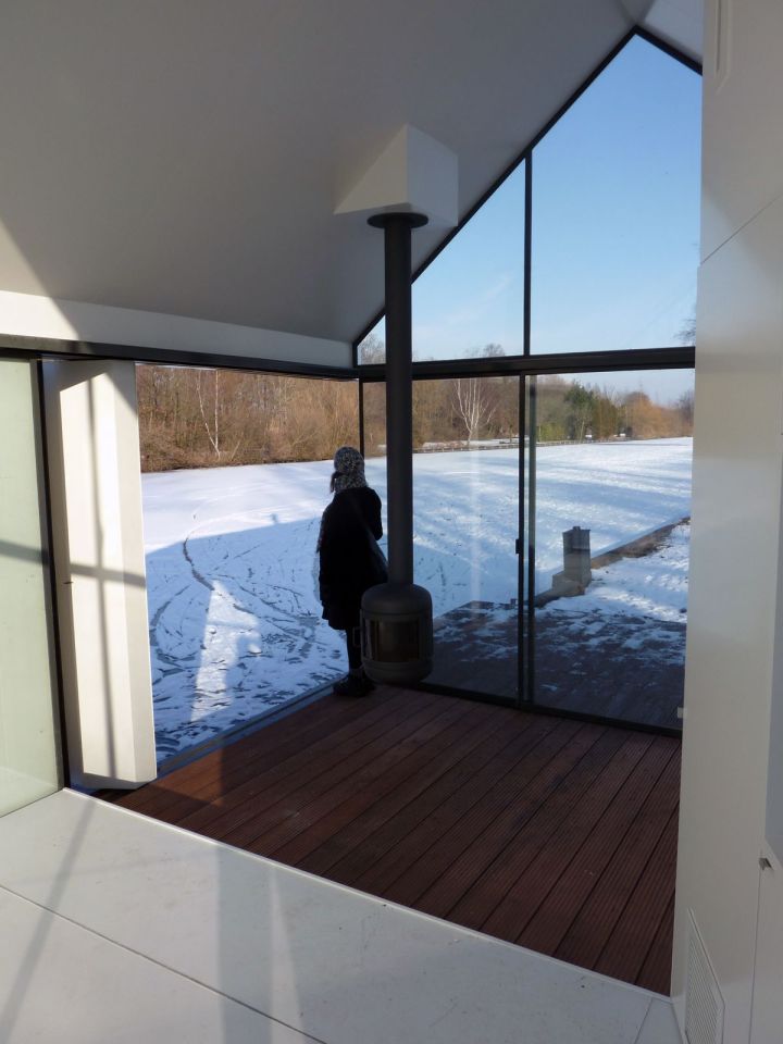 This tiny 226 sq ft lake house opens to the outdoors with a folding wall. 2by4-architects has also designed a prefab version. | www.facebook.com/SmallHouseBliss