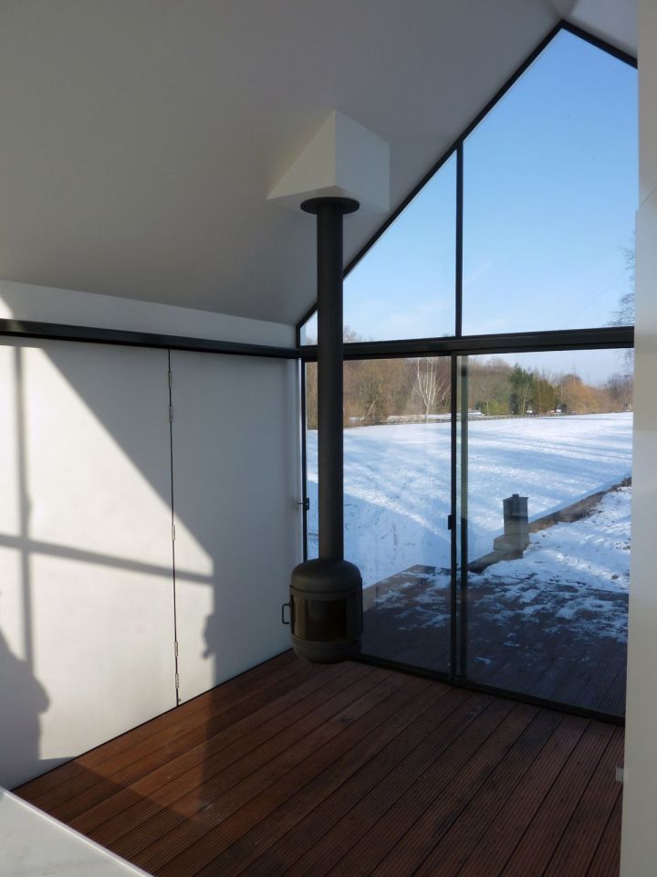 This tiny 226 sq ft lake house opens to the outdoors with a folding wall. 2by4-architects has also designed a prefab version. | www.facebook.com/SmallHouseBliss