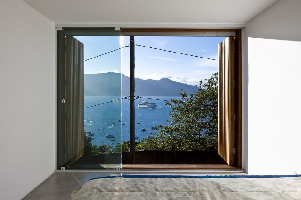 A small house in Brazil with traditional stone walls topped by a modern concrete box. It has 1 bedroom in 387 sq ft. | www.facebook.com/SmallHouseBliss