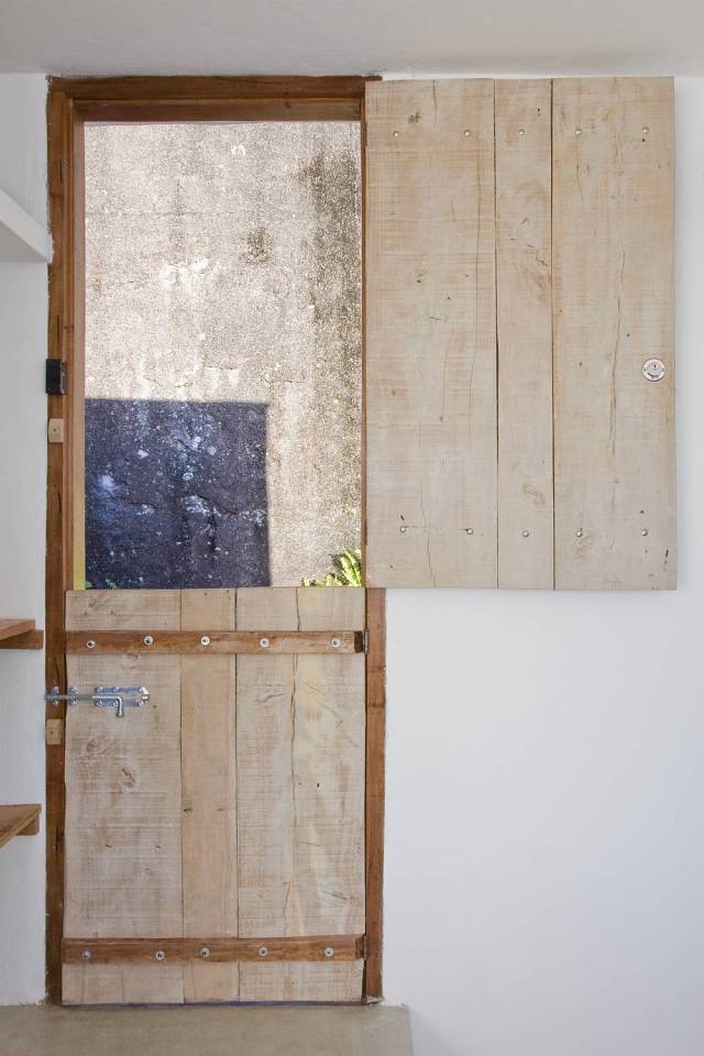 A small house in Brazil with traditional stone walls topped by a modern concrete box. It has 1 bedroom in 387 sq ft. | www.facebook.com/SmallHouseBliss