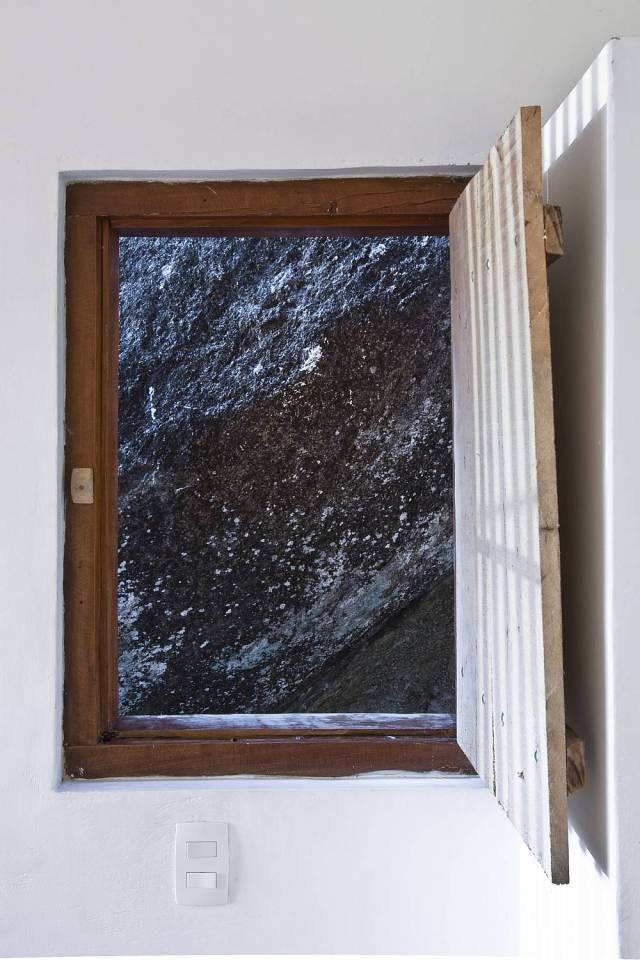 A small house in Brazil with traditional stone walls topped by a modern concrete box. It has 1 bedroom in 387 sq ft. | www.facebook.com/SmallHouseBliss