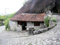 A small house in Brazil with traditional stone walls topped by a modern concrete box. It has 1 bedroom in 387 sq ft. | www.facebook.com/SmallHouseBliss