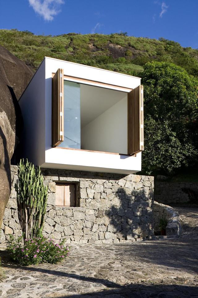 A small house in Brazil with traditional stone walls topped by a modern concrete box. It has 1 bedroom in 387 sq ft. | www.facebook.com/SmallHouseBliss