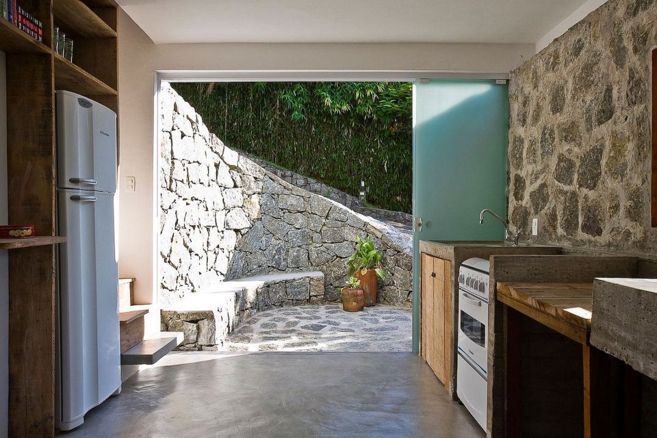 A small house in Brazil with traditional stone walls topped by a modern concrete box. It has 1 bedroom in 387 sq ft. | www.facebook.com/SmallHouseBliss