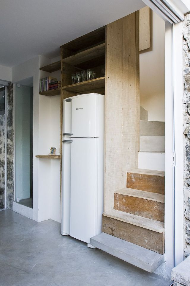 A small house in Brazil with traditional stone walls topped by a modern concrete box. It has 1 bedroom in 387 sq ft. | www.facebook.com/SmallHouseBliss