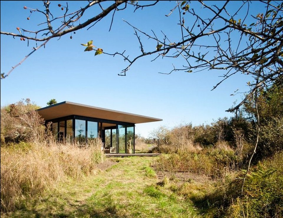 This modern cabin by Olson Kundig Architects is open to nature with glass walls on three sides. It has 500 sq ft of studio living space. | www.facebook.com/SmallHouseBliss