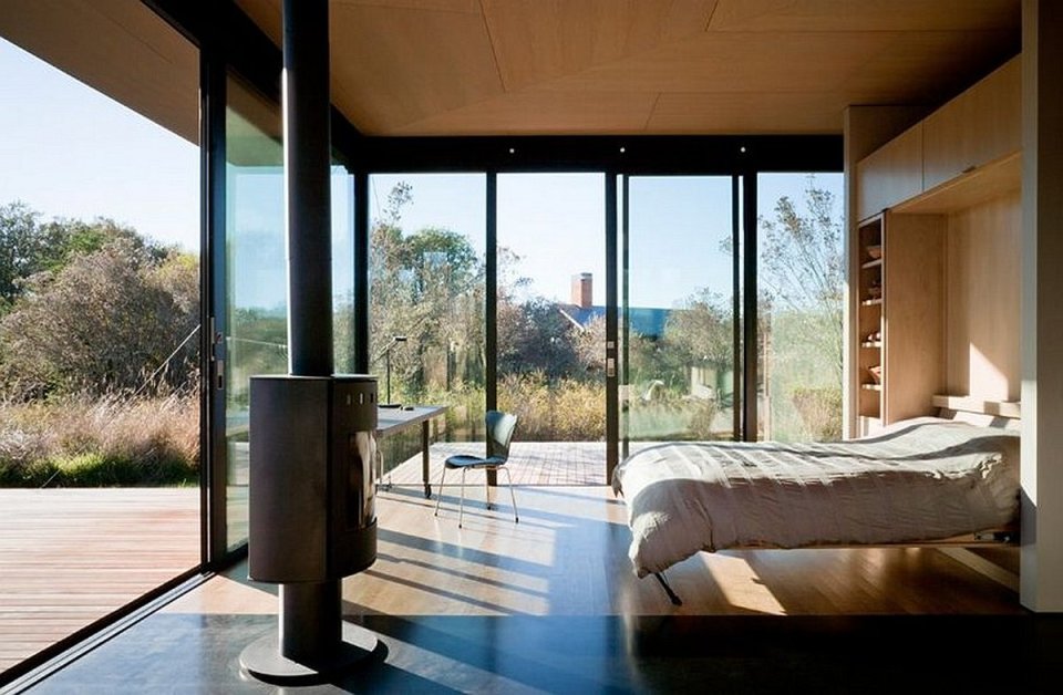 This modern cabin by Olson Kundig Architects is open to nature with glass walls on three sides. It has 500 sq ft of studio living space. | www.facebook.com/SmallHouseBliss