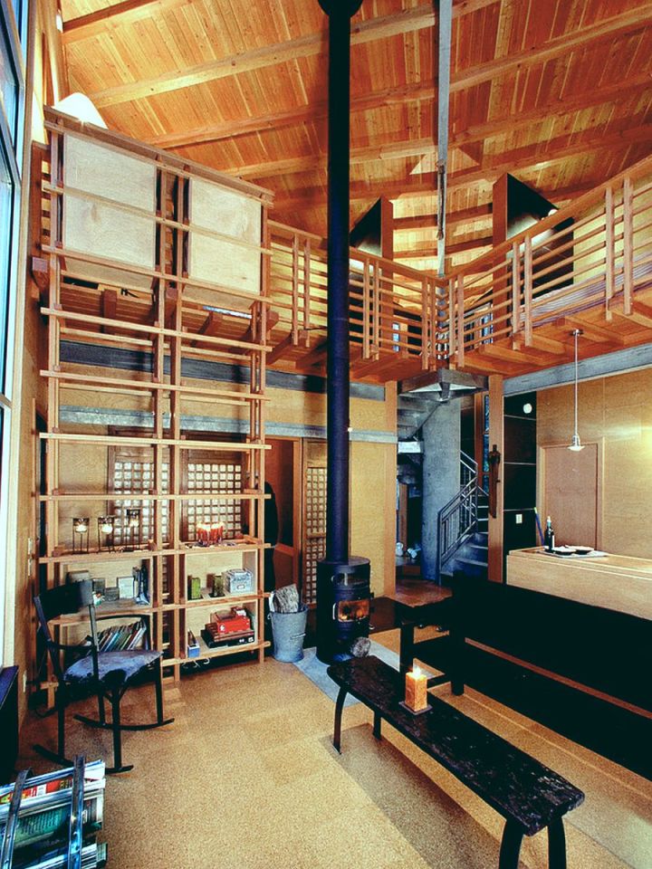 This elevated cabin features a double-height corner window. It has 800 sq ft and a pair of lofts for sleeping. | www.facebook.com/SmallHouseBliss