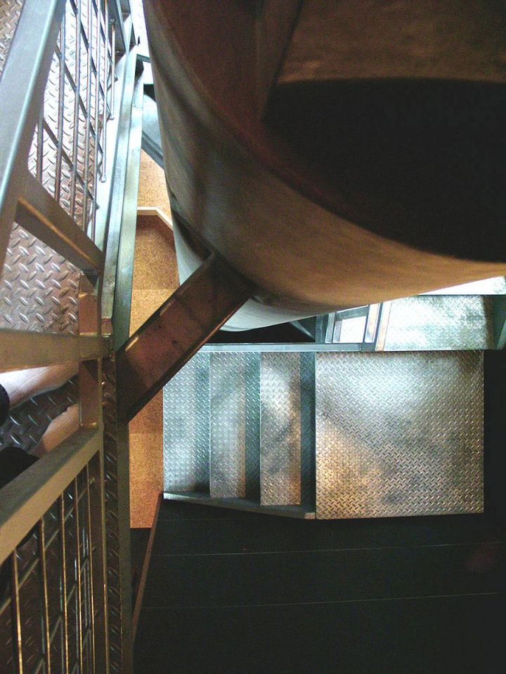 This elevated cabin features a double-height corner window. It has 800 sq ft and a pair of lofts for sleeping. | www.facebook.com/SmallHouseBliss