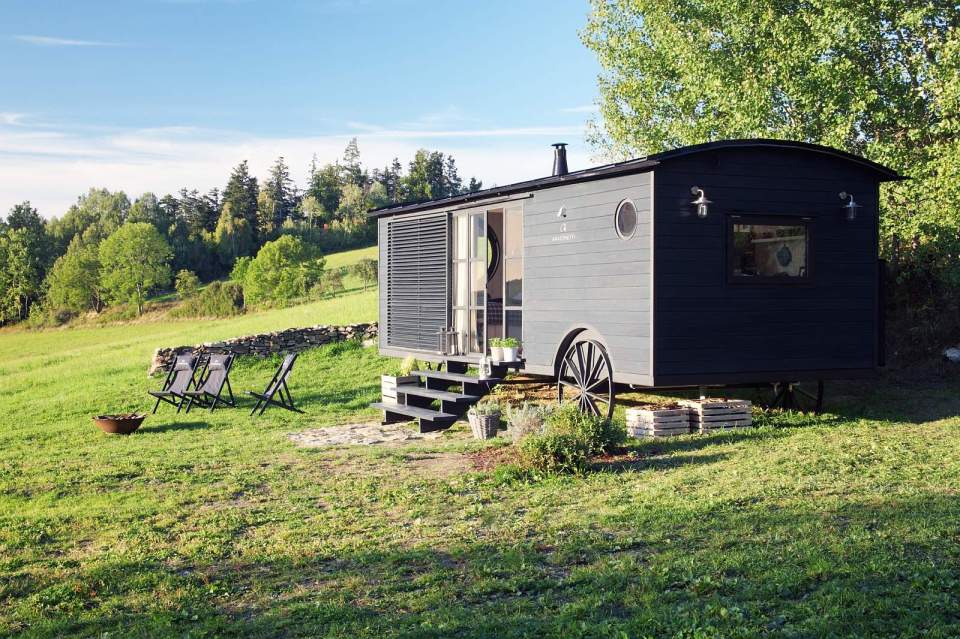 A modern version of the traditional wagon dwelling. It has a full kitchen, 3-piece bath and built-in bed in 258 sq ft. | www.facebook.com/SmallHouseBliss