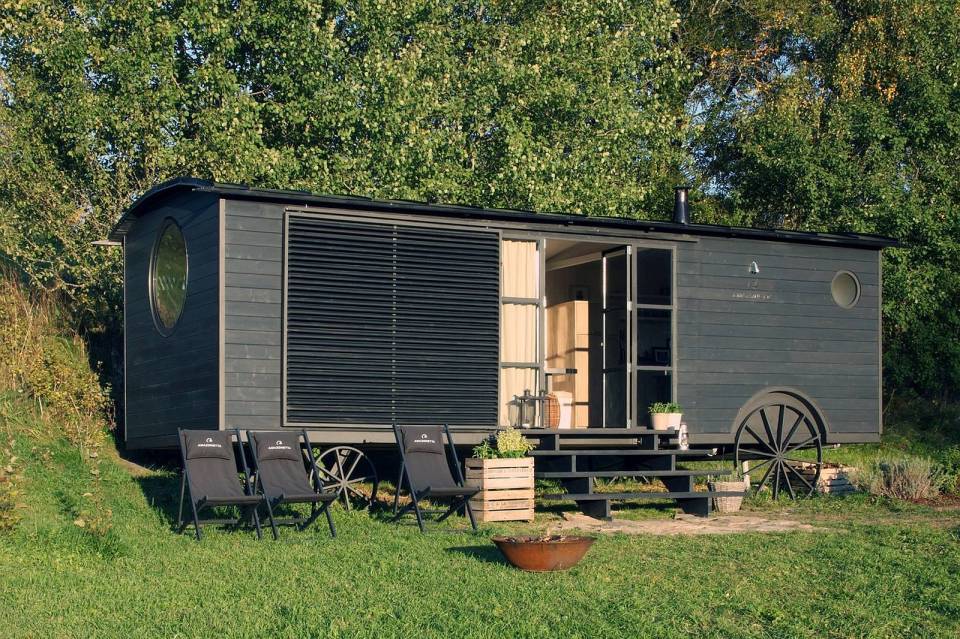 A modern version of the traditional wagon dwelling. It has a full kitchen, 3-piece bath and built-in bed in 258 sq ft. | www.facebook.com/SmallHouseBliss