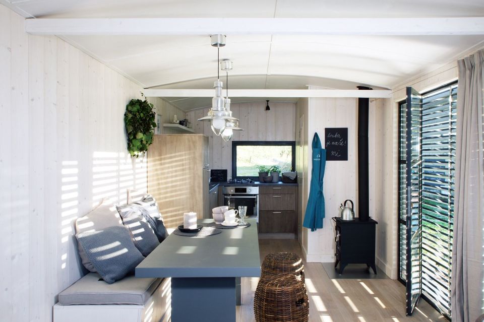 A modern version of the traditional wagon dwelling. It has a full kitchen, 3-piece bath and built-in bed in 258 sq ft. | www.facebook.com/SmallHouseBliss