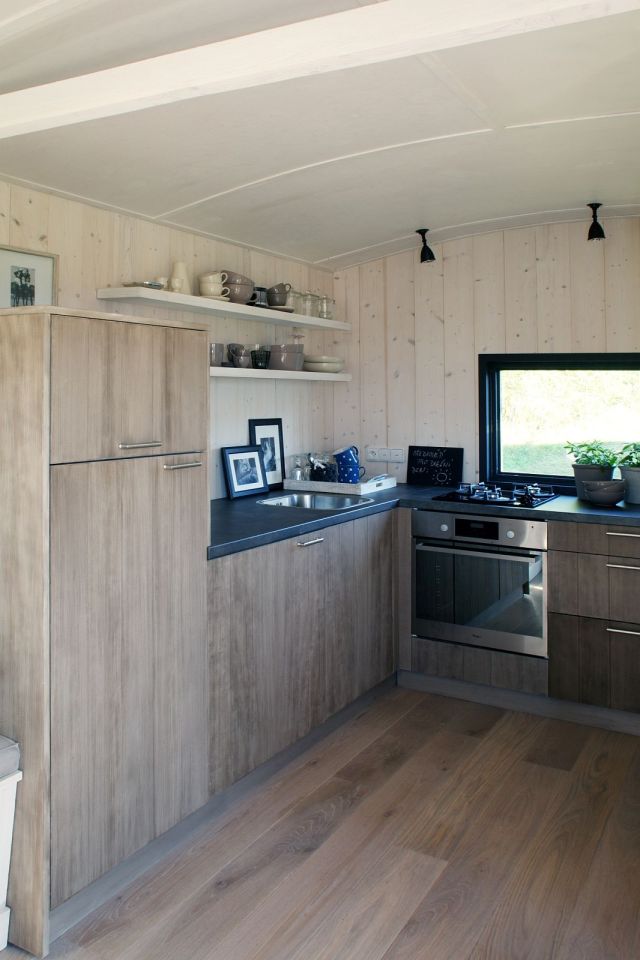A modern version of the traditional wagon dwelling. It has a full kitchen, 3-piece bath and built-in bed in 258 sq ft. | www.facebook.com/SmallHouseBliss