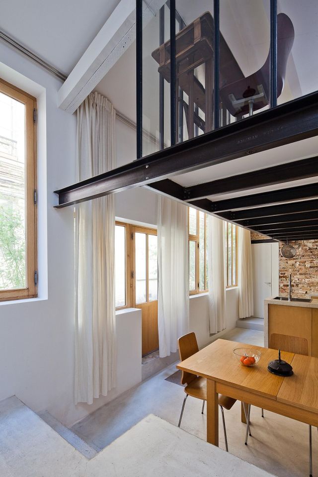 A dingy workshop in Paris was transformed into this bright and airy home with a glass-enclosed loft. | www.facebook.com/SmallHouseBliss